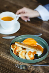 Delicious cheesecakes, pancakes with fruit, banana and caramel. Lunch, brunch