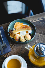 Delicious cheesecakes, pancakes with fruit, banana and caramel. Lunch, brunch