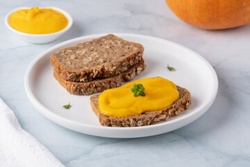 Sandwich with tasty pumpkin jam on table