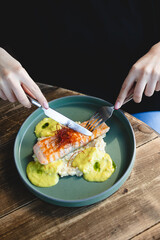 Salmon steak with avocado and spinach sauce.