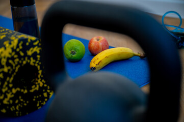 Grapes, nuts, and a yoga block set on the exercise mat. Nutrient boost for a mindful fitness session - 747593664
