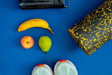 banana, apple, pear and exercise equipment placed on the mat. Replenishment of energy during training or workout - 747593858