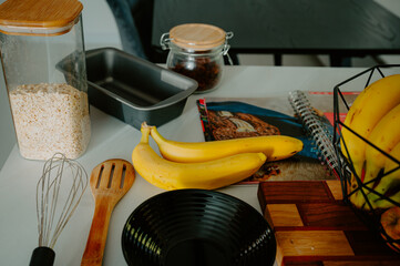 Gearing up for baking success: Fresh banana, pot, and cookbook in frame - 747594248