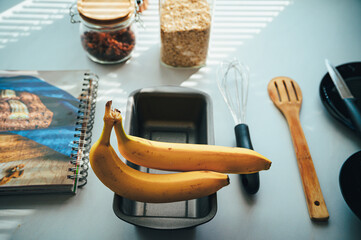 Baking essentials on a kitchen counter: Ingredients for perfect banana bread. - 747594671