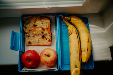 Breakfast packaging for school or work. Banana, apples and banana bread wrapped for a snack