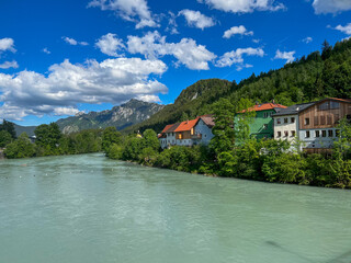 Fototapeta na wymiar Germany, Fussen - 2022, May: Lech River and Colours Houses 