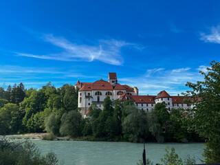 Fototapeta na wymiar Germany, Fussen - 2022, May: Lech River and Hohes Schloss 