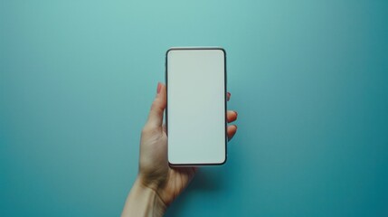 Close-up hand holding a phone with a blank white screen turned towards the camera. blue background