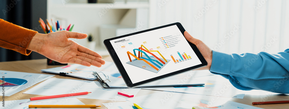 Poster startup company employee working together using tablet analyzing bi dashboard paper on financial dat