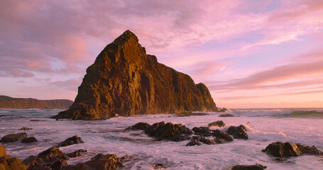 sunset view of lion rock at south cape bay in the wilderness of south west national park in...
