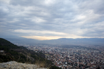 European mountain city seen from above at sunset on a cloudy day, Skopje the capital city.
