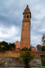 Fototapeta premium Famous leaning bell tower Campanile Pendente of Saint Martin Bishop Church on Burano island, Venice, Italy