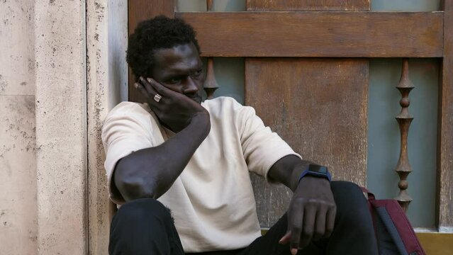 Weariness and Sorrow: Black Man Seated by Doorway