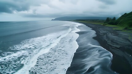 Black, volcanic beach, Aerial drone view of moody atlantic ocean wave on black sand beach in summer
