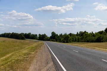 paved road along and blue sky