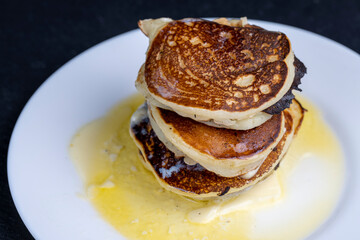delicious cooked pancakes with cottage cheese and melted butter