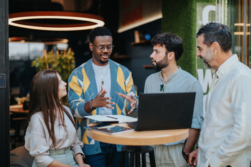 Multiracial businesspeople discussing projects for better efficiency and profitable outcomes. Successful teamwork achievements and workplace productivity principles for a multinational company.