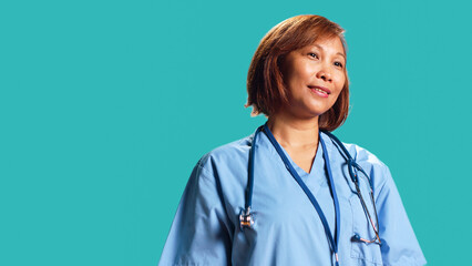 Happy proficient BIPOC nurse smiling while looking at camera. Portrait of cheerful asian healthcare...
