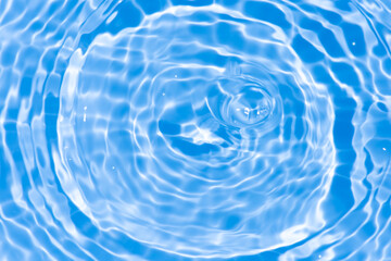 Blue water surface texture with ripples, splashes, and bubbles. Abstract summer banner background...