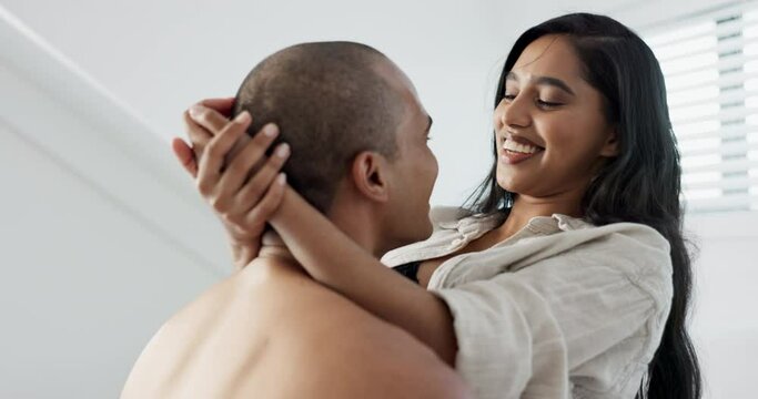 Couple, hug and kiss in bedroom with smile for love and commitment, romance for happiness and chemistry. People in healthy relationship, bonding and care at home with trust and partner for life