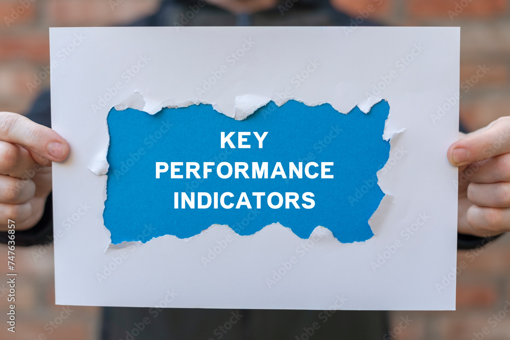 Poster man holding white and blue sheets of paper with text: key performance indicators. key performance in