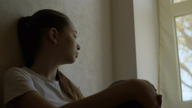 Solitude Sorrow: Young Woman's Grief by the Window at Home