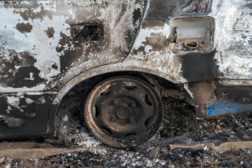 A burned out car. Burnt car in the field. Car fire, vehicle fire due to short circuit. Stolen car...