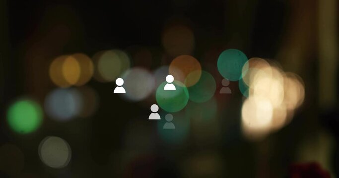 Animation of social media icons over light spots on black background