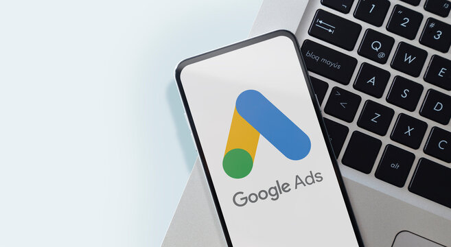 Google Ads Words on smartphone screen.Closeup of mobile phone over a laptop keyboard. Rosario, Argentina - February 28, 2024.