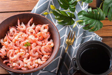 Boiled peeled shrimp with soy sauce on a plate. Dietary seafood