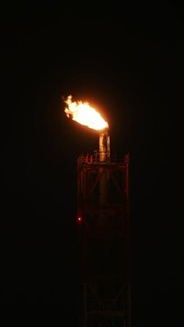 Flare stack at low temperature. Night scene. Telephoto lens