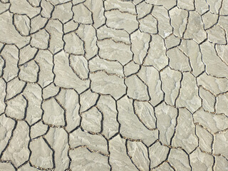 background texture of stone pavement tiles with small cracks at the joints. blocks of different shapes and sizes are precisely adjusted to each other