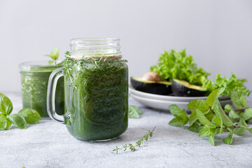 Blended green smoothie with ingredients. Healthy smoothie