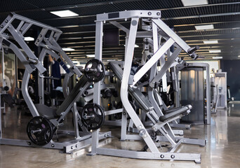 Interior of modern gym with weight training machines for beginners and professional athletes....