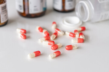 Medicine pills, drugs in different colours arranged on a white background. Health care medical concept.