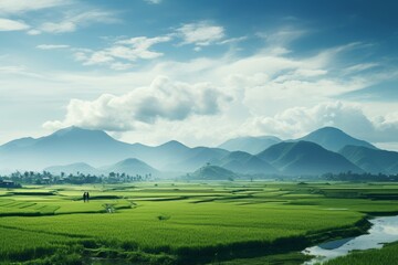 Tranquil landscape with terraced rice fields, majestic mountains, a meandering river, and a serene blue sky with fluffy clouds. Ideal for nature-themed designs and relaxation concepts.