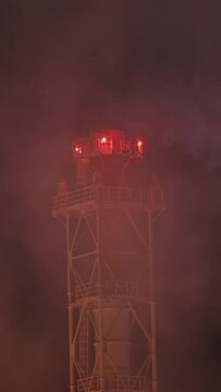 Smoking factory chimney, close-up. Gas and oil refineries. Exhaust gases and steam at very cold weather with night sky.