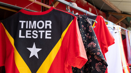 Close up of t-shirt with Timor-Leste flag hanging at tourism market stall in Dili, Southeast Asia