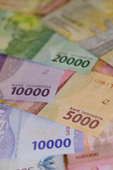 Close up of Rupiah banknotes. The rupiah is the official currency of Indonesia issued and controlled by Bank Indonesia