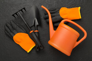 Orange gardening tools on conctere background, top view © Liami