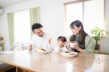 Image of a happy family around a dining table in the dining room wide-angle