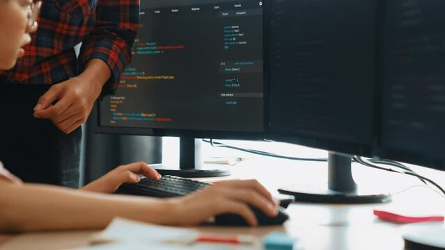 Slow motion back end or software developer manager supervising his team on new application program development on debugging and solving complex code algorithms on monitor. Burgeoning