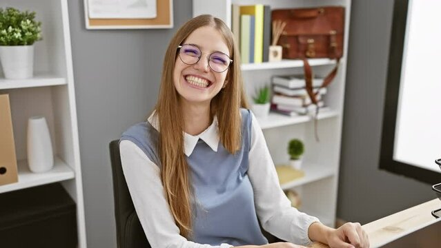 Crazy fun at the office, beautiful young blonde business worker making a comical fish face. funny expression with puckered lips - a mad, cheerful gesture!