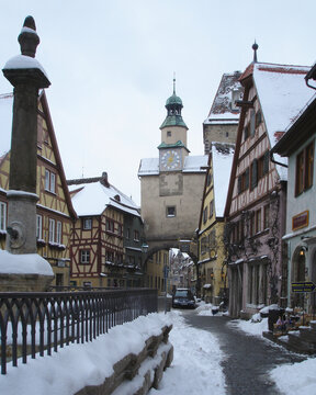Snow covered street leading to Röderbogen Arch in Rothenburg ob der Tauber  Bavaria  Germany  January 2007. architecture  church  tower  city  building  winter  europe  old  cathedral  town  snow  rel