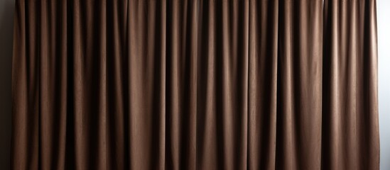 Obraz premium A living room with a brown fabric curtain hanging on a metal rail, providing privacy and light control. In the room, there is a cozy couch, a comfortable chair, and a window that lets in natural light