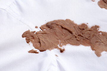 Dirty stain chocolate ice cream  on white clothes