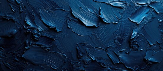 A close-up photograph showcasing a gypsum painted texture with an uneven surface, creating an abstract dark blue background that is perfect for presentations and design projects.