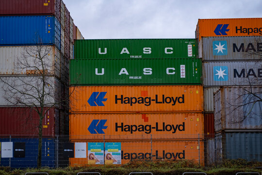 Shipping containers largest shipping and transportation companies stacked in port, Hapag-lloyd, COSCO, OOCL, Evergreen, Logistics and supply chain management, Frankfurt, Germany - January 21, 2024