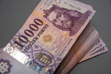 Hungarian banknote bundle money (forint) 10,000 HUF banknotes spread out on a table, close-up as background. Europe Hungary.