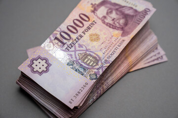 Hungarian banknote bundle money (forint) 10,000 HUF banknotes spread out on a table, close-up as background. Europe Hungary.